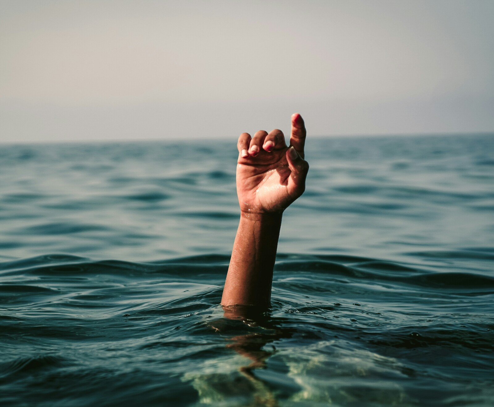 Someone's hand sticking out from underwater