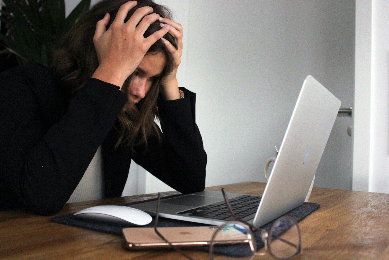Stressed out professional woman in front of a laptop.